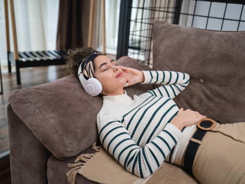 woman-relaxing-with-a-headphone-on-the-sofa