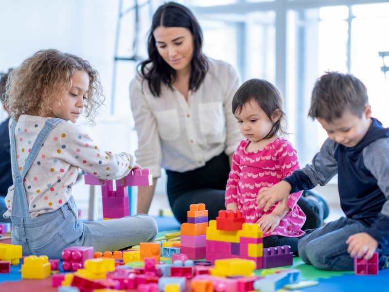 woman-with-kids-playing-with-toys