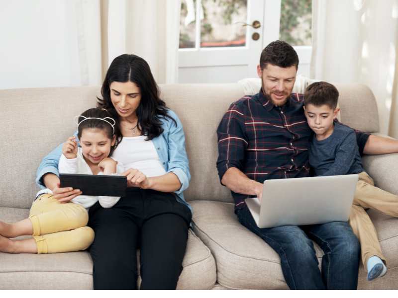 photo-of-family-on-sofa-trying-to-make-their-kids-study-without-yelling