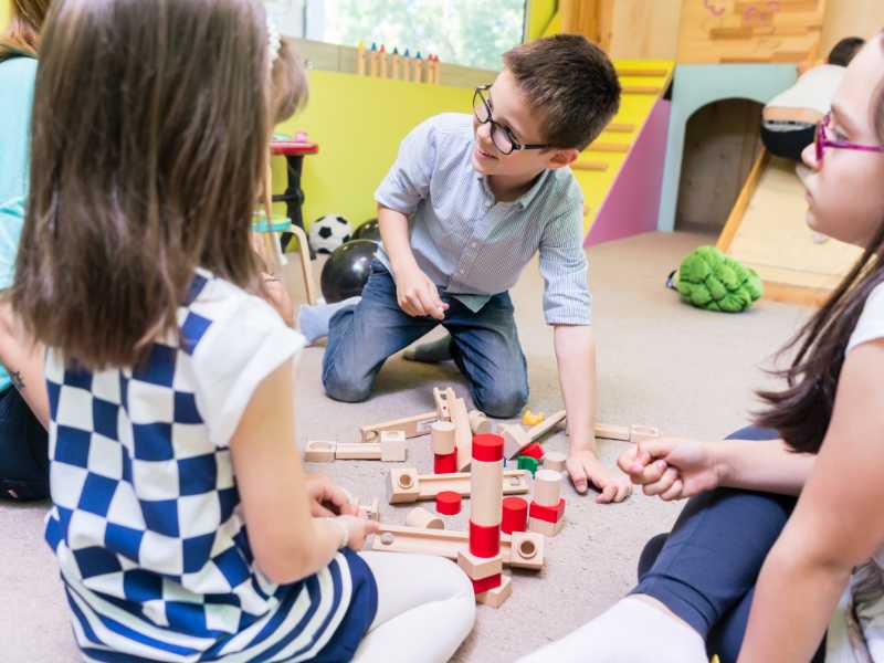 kids-playing-outside-with-wooden-structure