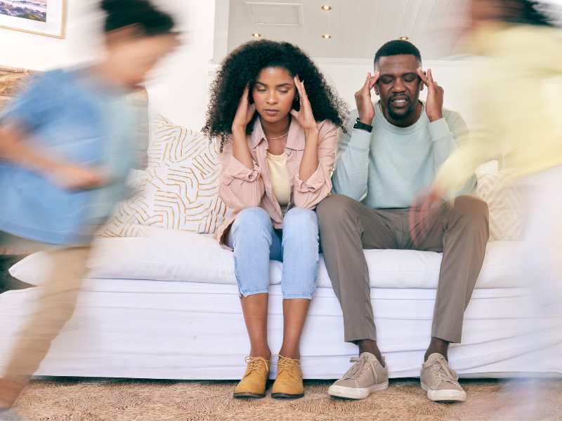 parents-sitting-on-sofa-reflecting-on-past-experience-with-ways-to-discipline-kids-without-yelling