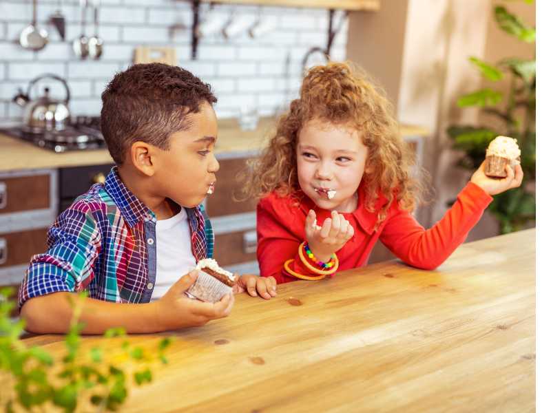 little-boy-and-girl-by-the-table-talking