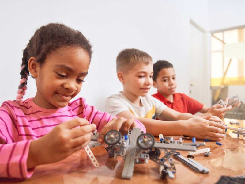 three-multiracial-kids-creating-toys