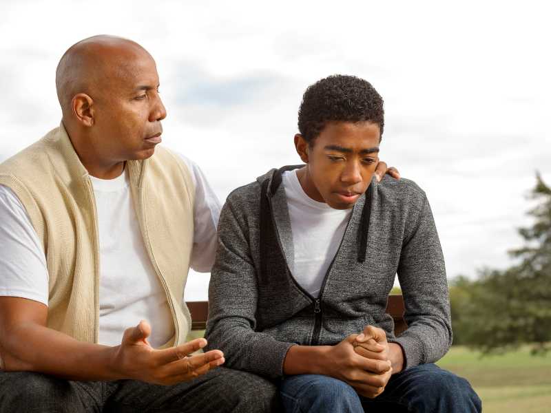 father-talking-with-son-to-reinforce-=self-esteem