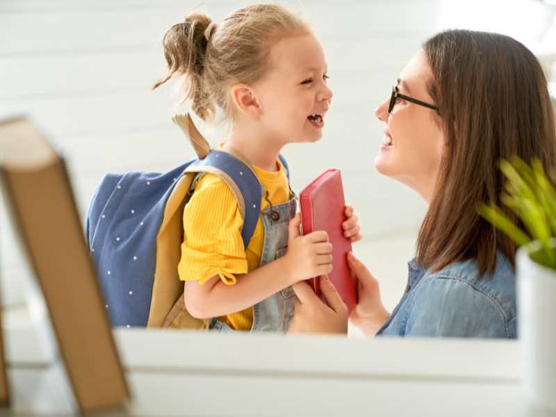 woman-with-little-girl-carrying-a-back-pack