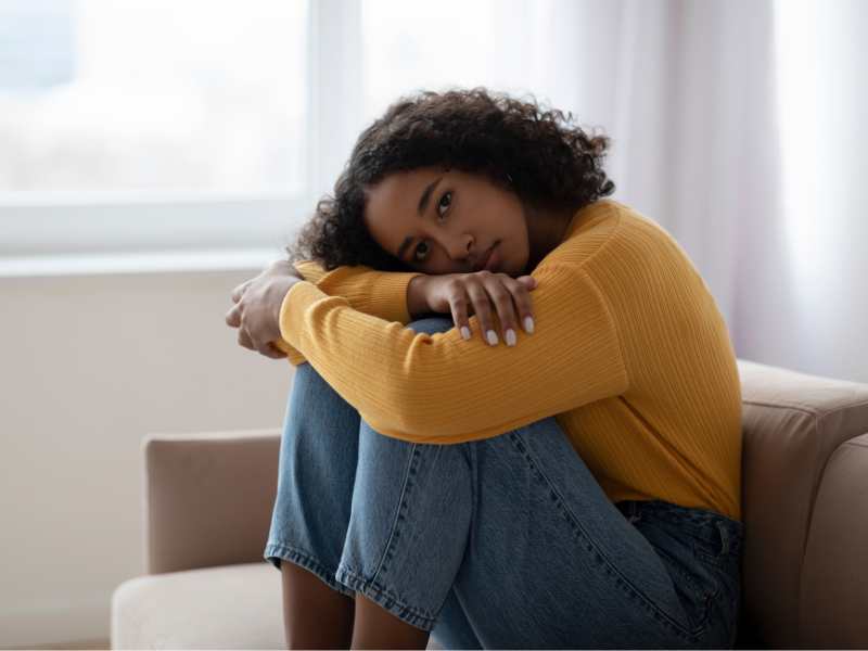 woman-on-yellow-shirt-experiencing-perineal-pain