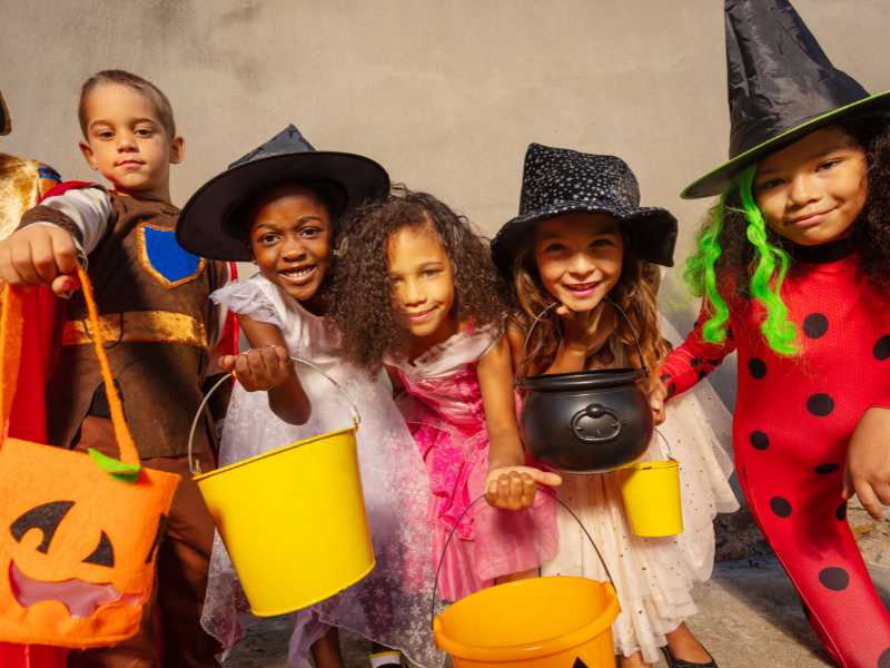 children-gathered-as-witches-and-warlocks-a-creative-Halloween-gender-reveal-for-2024