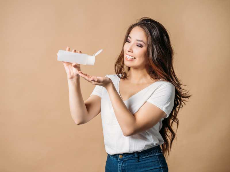 woman-on-white-top-applying-hair-hair