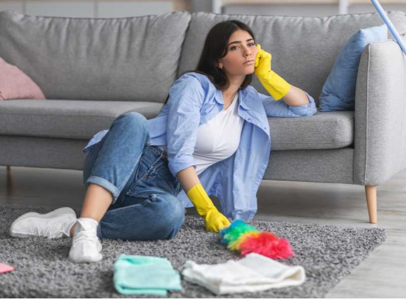 woman-with-cleaning-gloves-sitting-on-the-floor-for-cleaning-routines