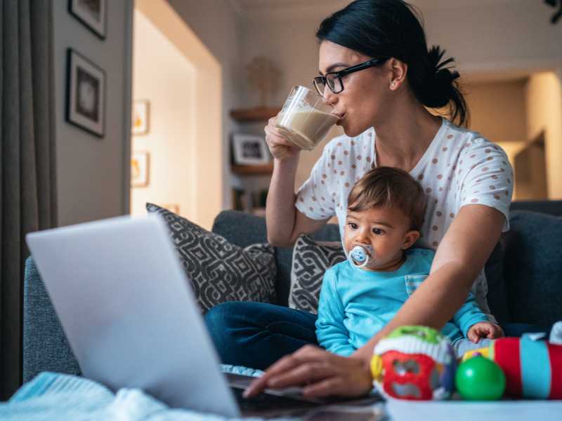 mother-with-baby-using-laptop-at-home