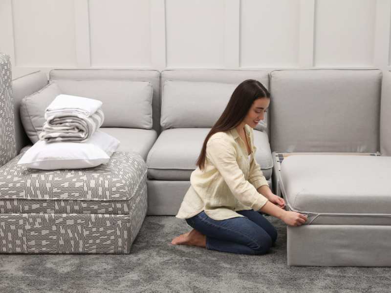 woman-converting-sofa-to-sleeping-space