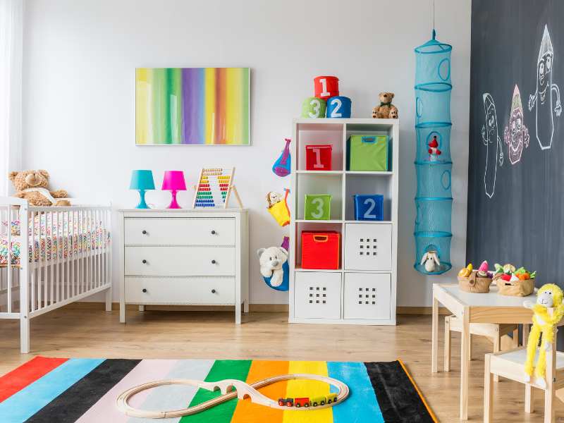 bright-baby-room-full-of-color-with-white-furniture-and-toys