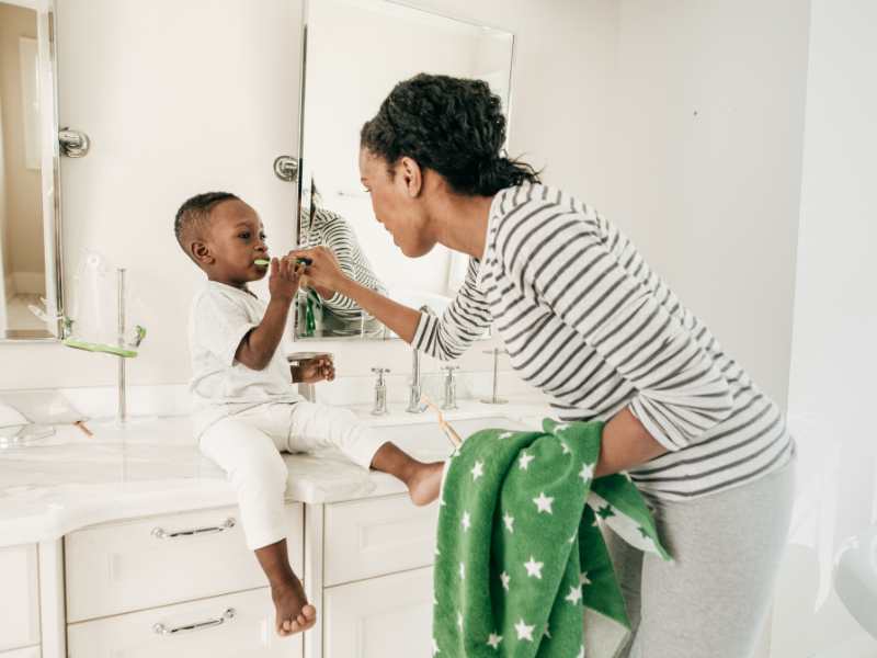 mom-doing-teeth-brushing-routine-with-toddler