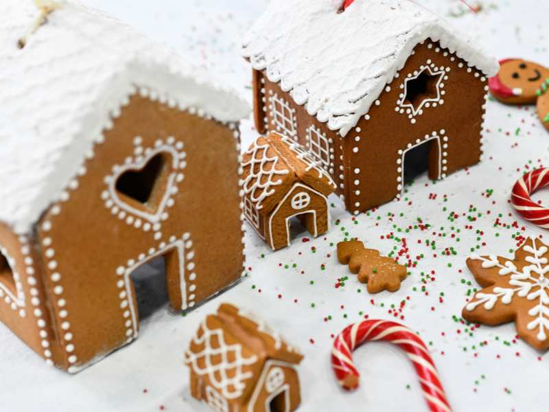 ginger-bread-houses-on-a-light-surface-with-sugar-cane