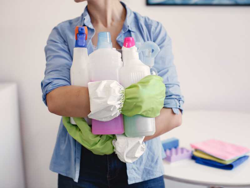 woman-with-different-cleaning-supplies