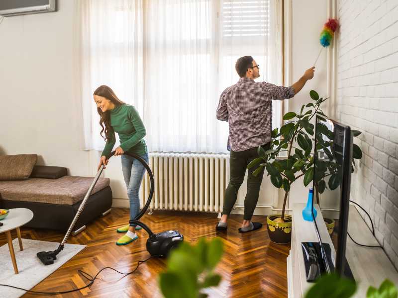 woman-and-man-cleaning-living-room-together-for-a-well-organized-home