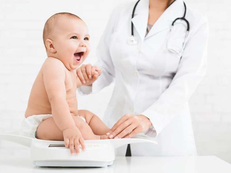 doctor-checking-baby's-weight-with-a-scale