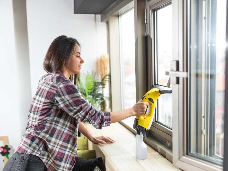 woman-with-brown-shirt-cleaning-windows