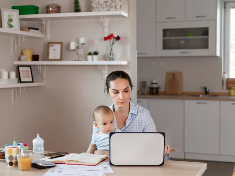 woman-carrying-son-managing-home-office