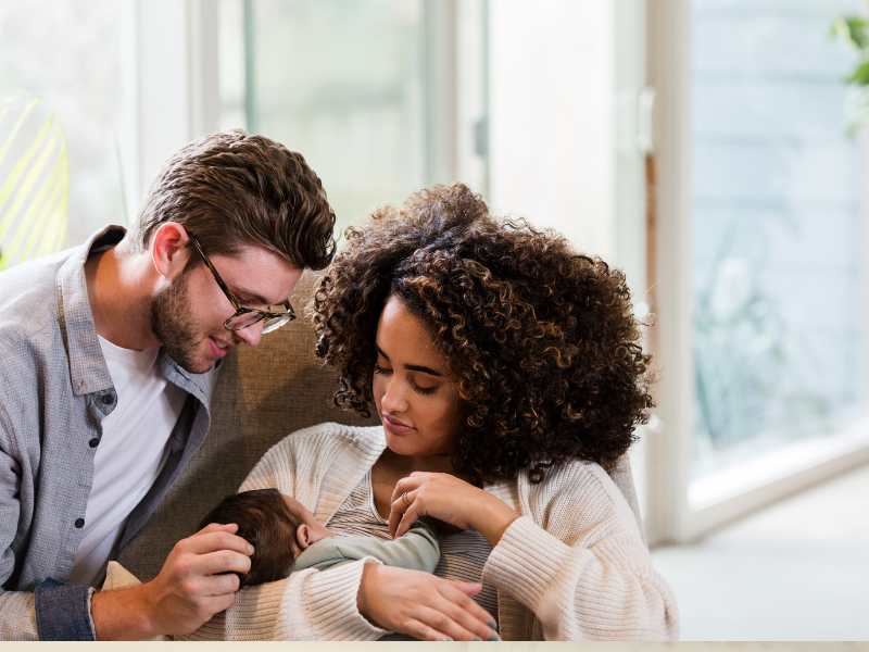 man-and-woman-watch-baby-breastfeed