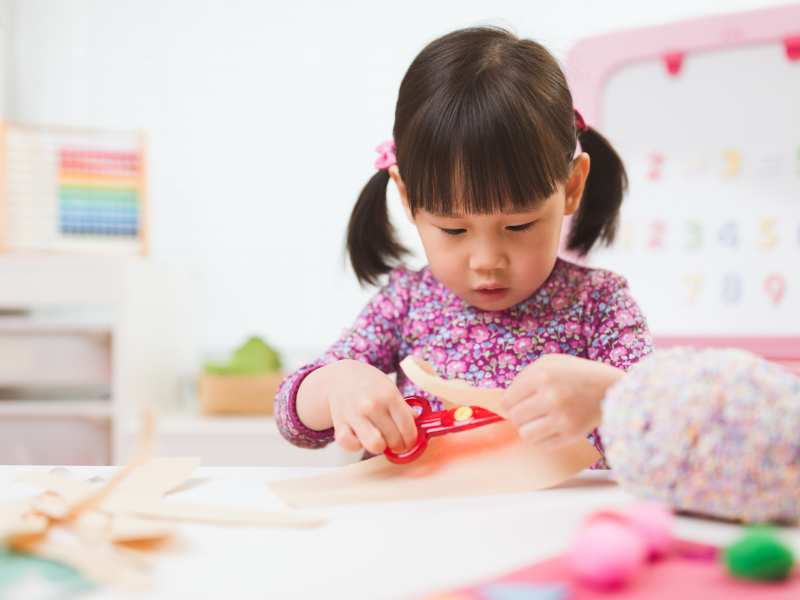 little-girl-making-tube-with-paper-towel-a-safe-indoor-activites-for-toddlers