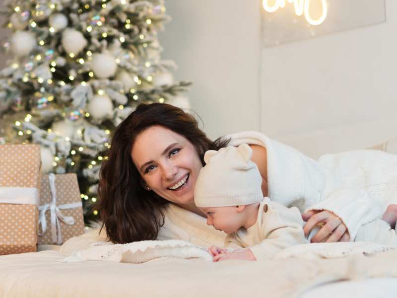 mom-and-baby-on-bed-with-covering-white-blanket