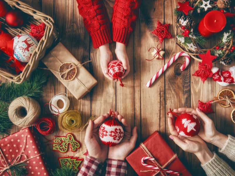 a-family-of-three-presenting-their-christmas-puzzle-game-all-on-red-cloths