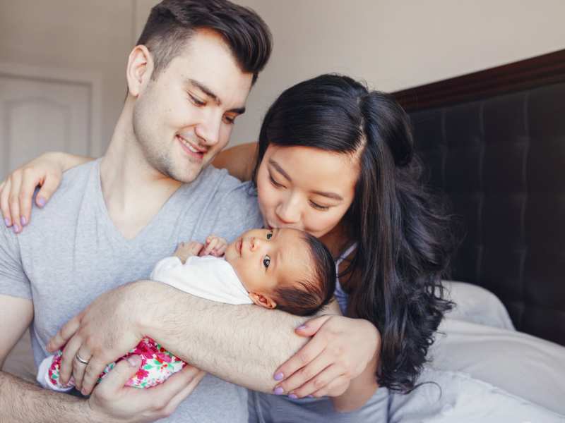 parents-carrying-their-baby-smiling