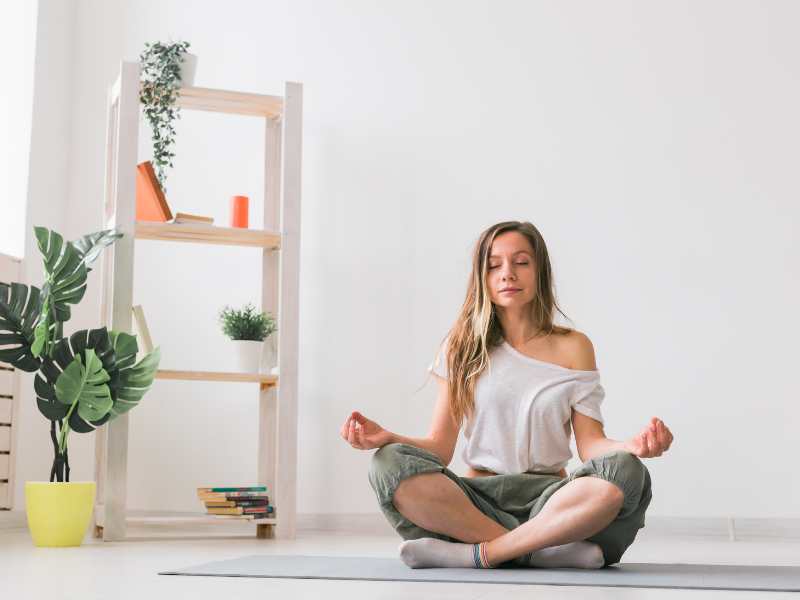 a-woman-sitting-on-the-floor-meditating