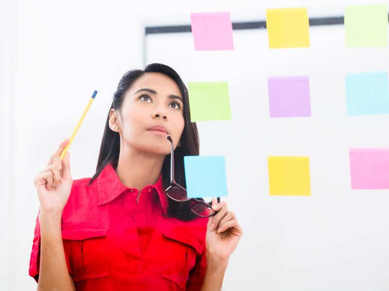 woman-looking-at-task-list-on-the-wall