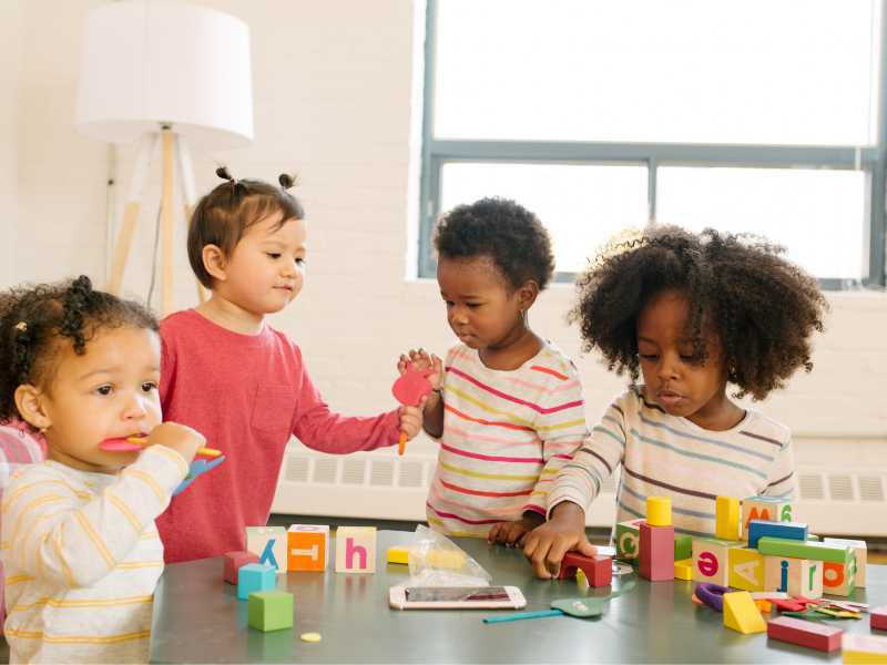 kids-of different-race-playing-indoor-with-toys