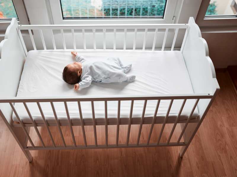 baby-sleeping-in-high-crib-bed