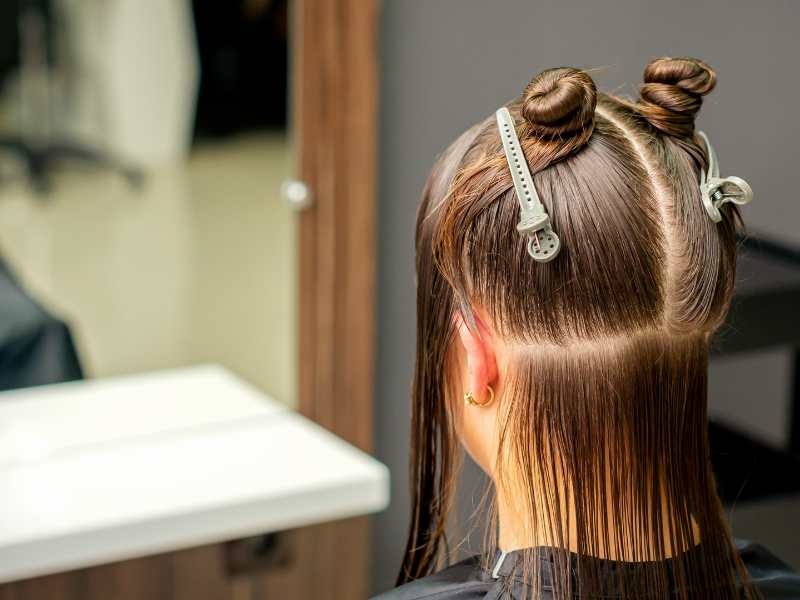 woman-with-sectioned-hair-in-the-salon