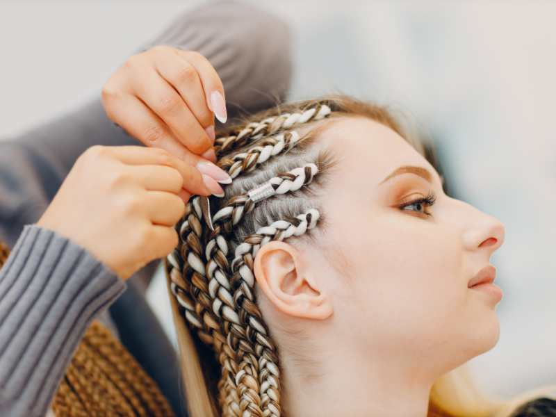 woman-cornrowing-hair