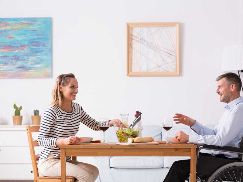 woman-with-man-on-wheelchair-on-table