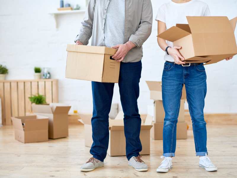 man-and-woman-carrying-brown-carton