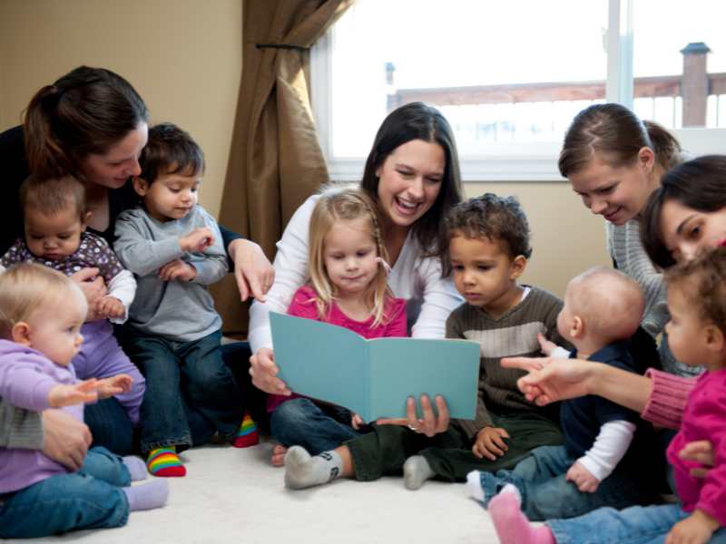 group-of-young-mothers-and-their-children-enjoy-story-time