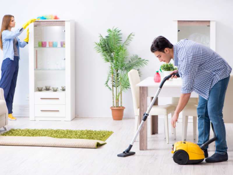 a-man-or-woman-cleaning-with-vacuum