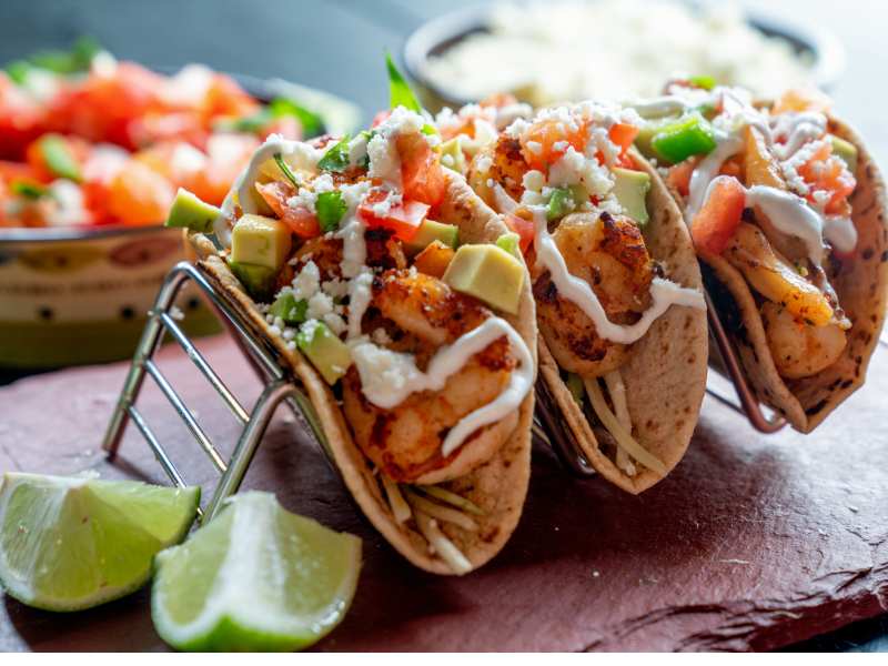 shrimp-street-tacos-with-toppings-like-avocado-sour-cream-and-cheese