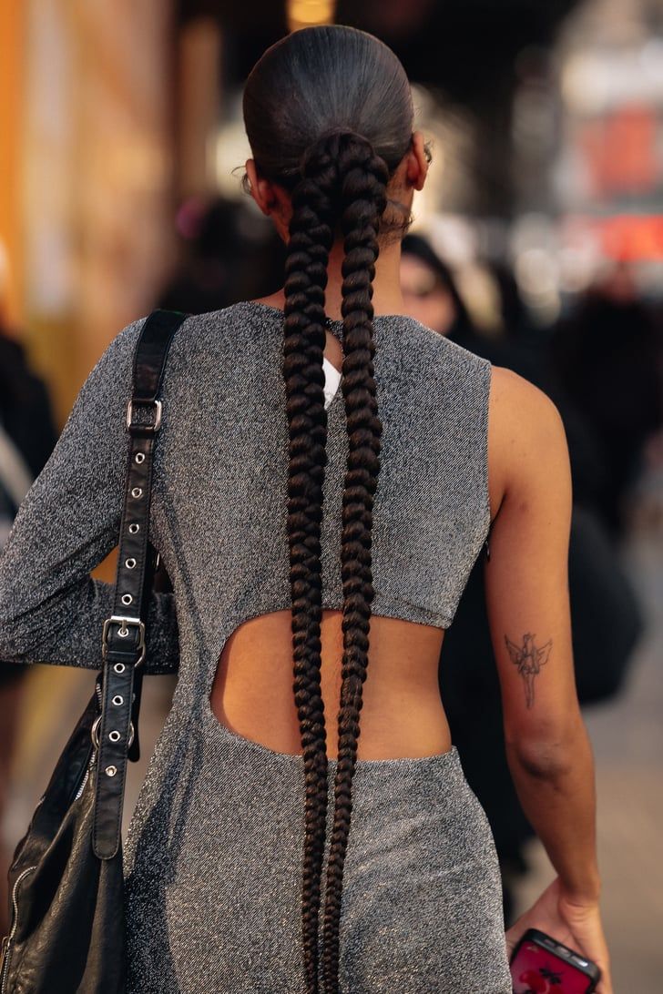 woman-on-grey-colour-jumpsuit-with-braided-low-ponytail-hairstyle