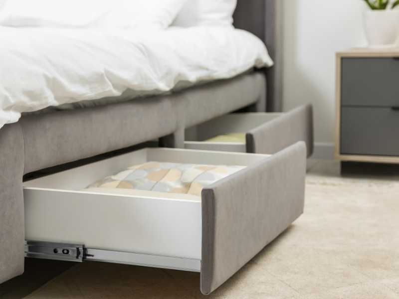 a-white-and-grey-bed-with-under-bed-drawers