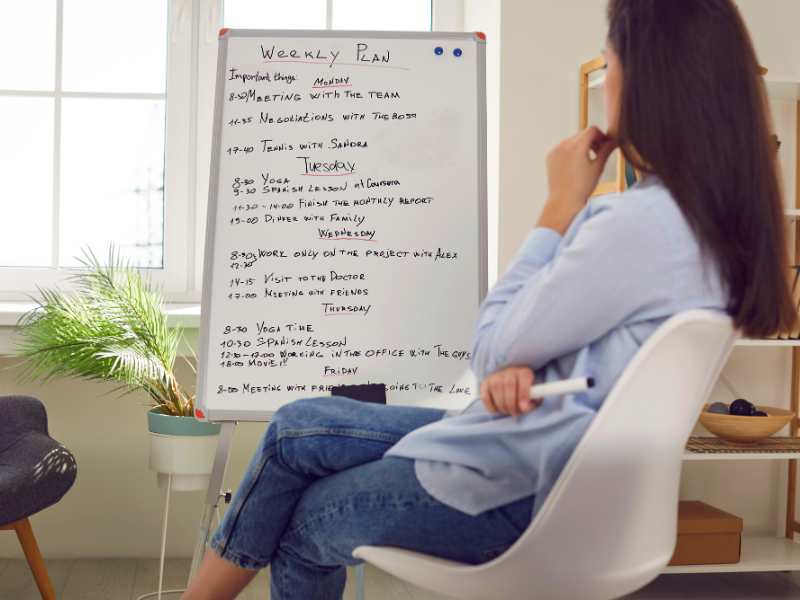 woman-looking-at-schedule-on-a-white-board