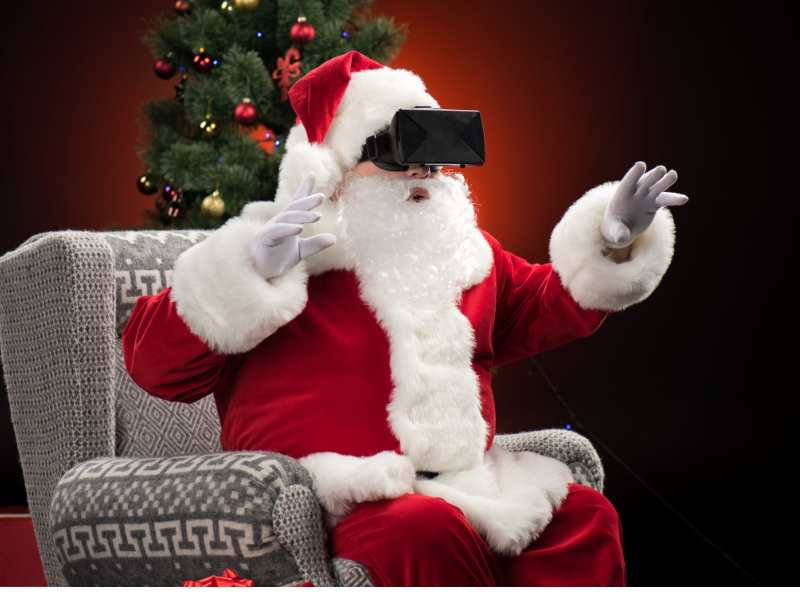 Santa-sitting-on-a-grey-chair-wearing-a-virtual-reality-headset