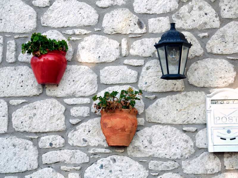 four-flower-vase-on-a-brick-wall