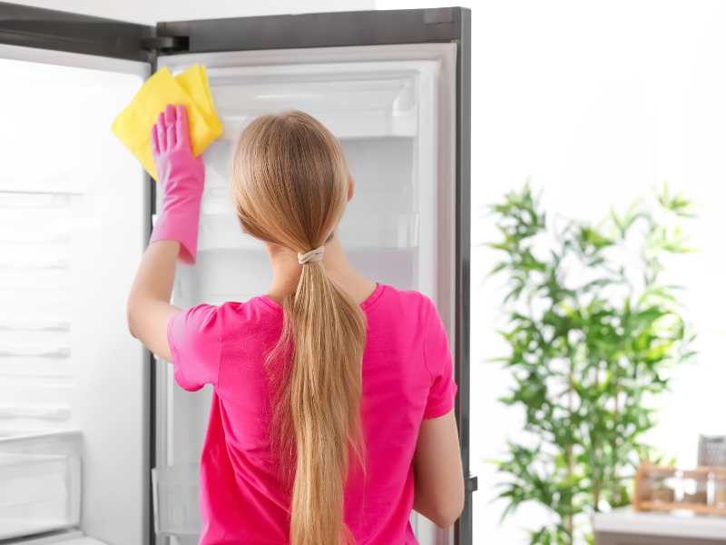 cleaning-routines-of-a-woman-with-blonde-hair-cleaning-refrigerator-in-kitchen