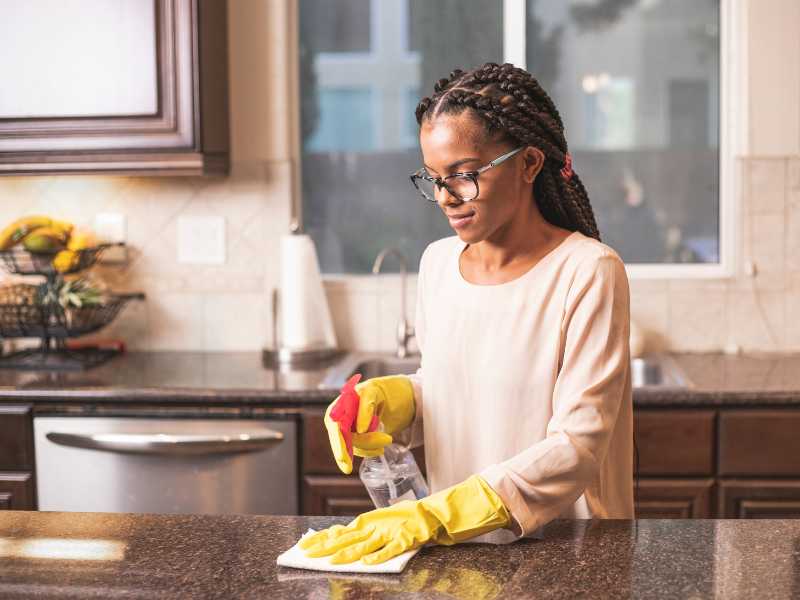 an-African-American-woman-cleaning-and-disinfecting-surface