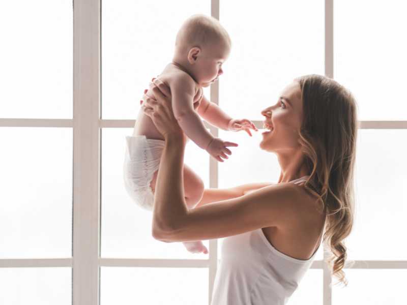 young-mom-playing-with-child-by-the-window