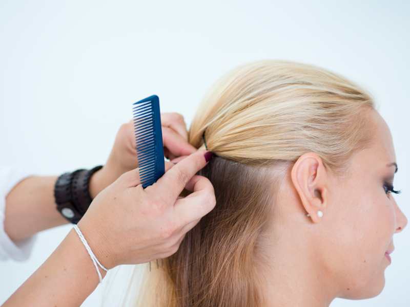 woman-with-comb-to-make-cornrow-on-a-straight-hair