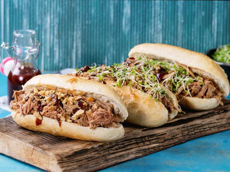 pulled-pork-sandwiches-served-on-wood-cutting-board