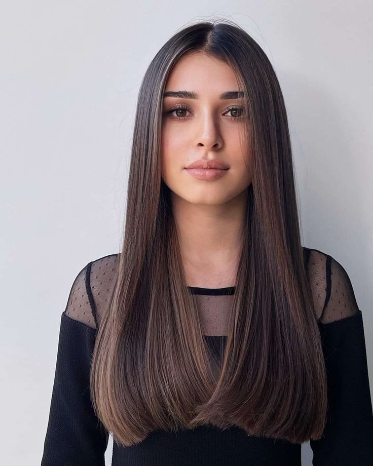 a-beautiful-young-woman-on-black-top-with-middle-parting-sleek-hairstyle